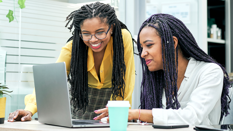 Two women looking at computer